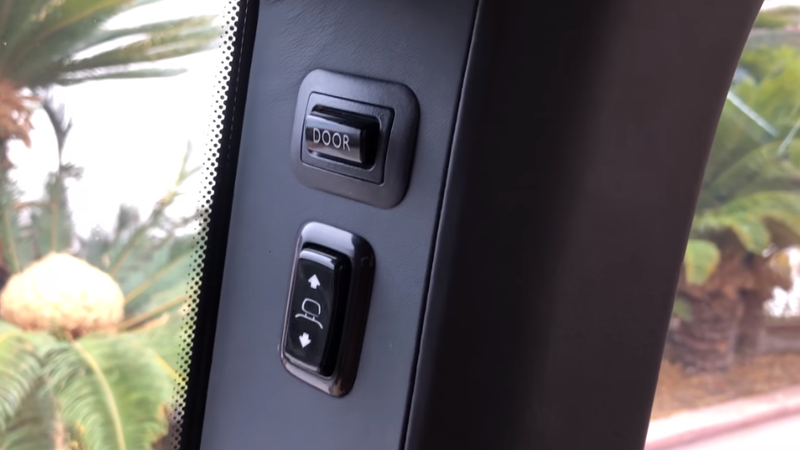 Tacked on buttons for closing the rear doors, and moving the rear seat headrests
